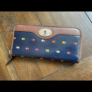Fossil Navy Blue Wallet with Multicolor Dot Pattern and Brown Trim.